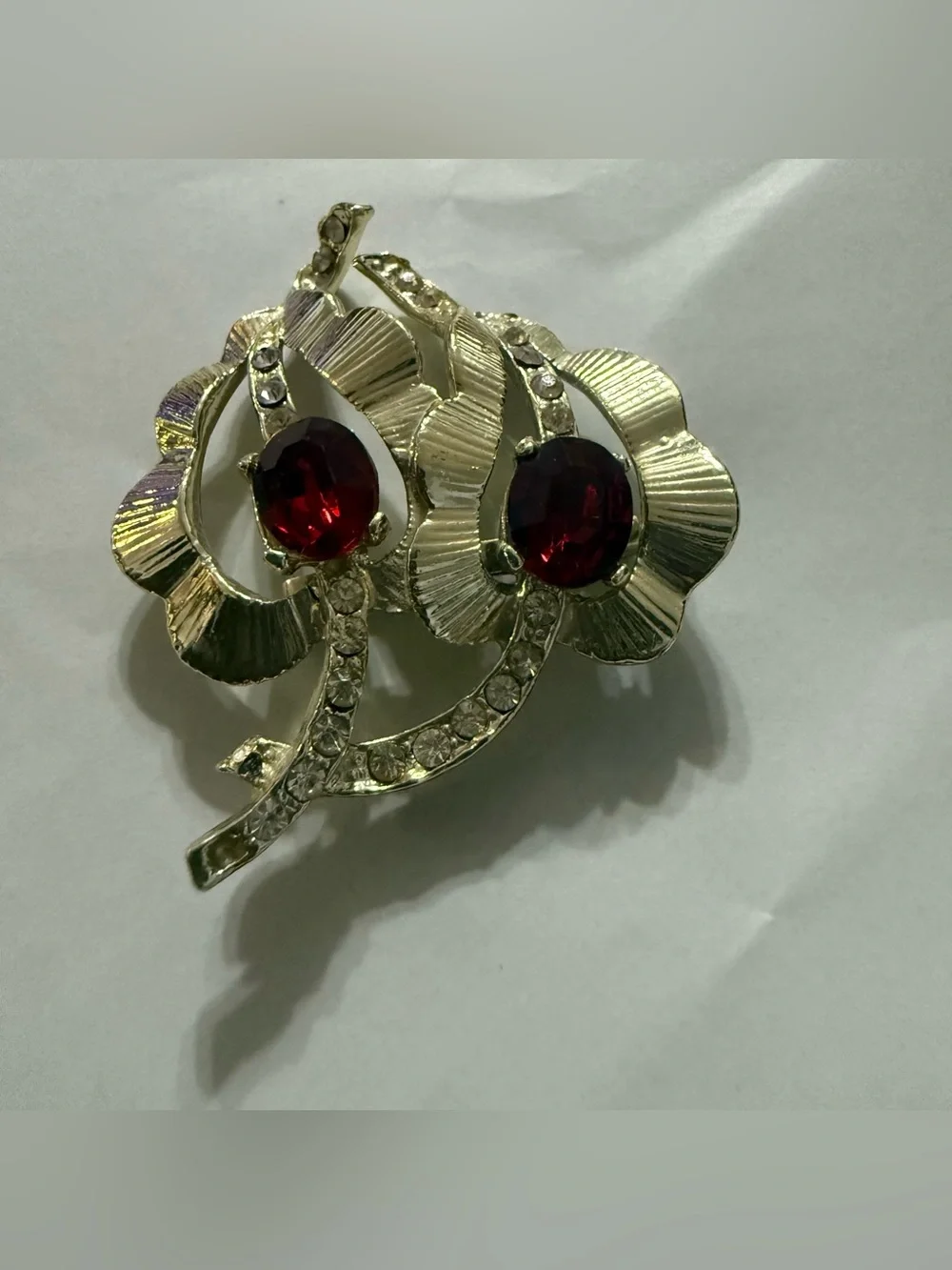 Vintage gold tone leaf brooch with red and clear rhinestones